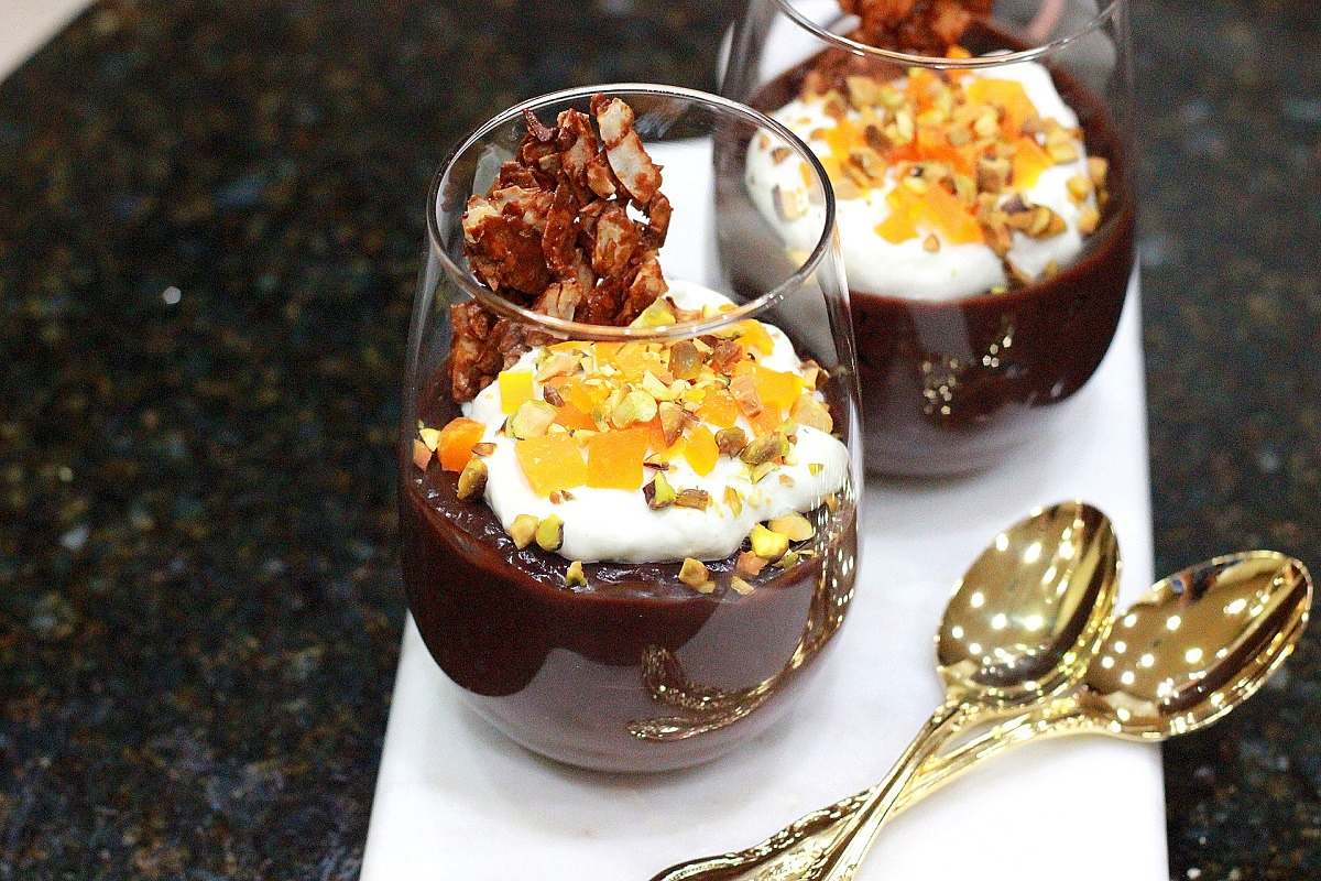 chocolate and coconut pudding in glass with silver spoons