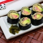 Spicy Tuna Rolls with Sea Grapes on white platter
