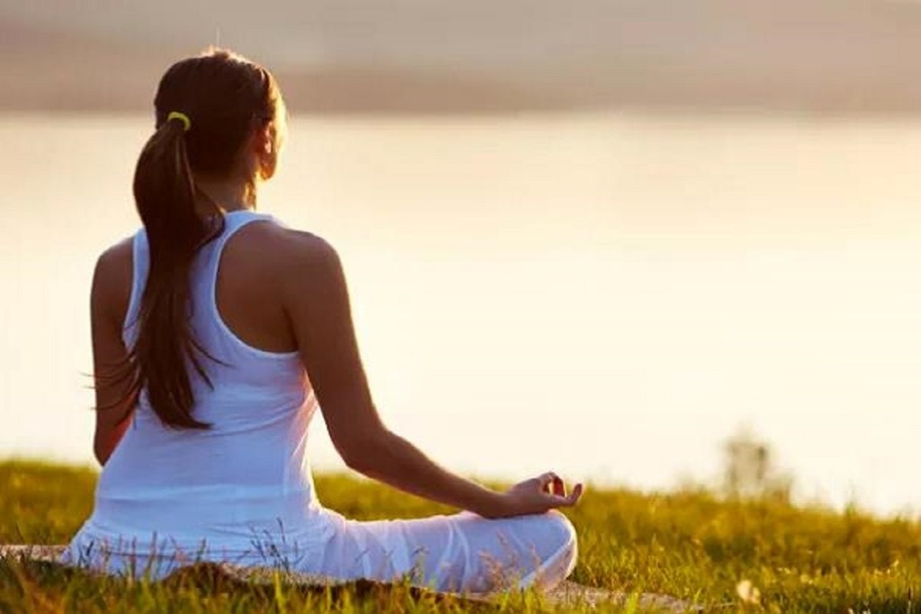 woman sitting in meditation pose outside