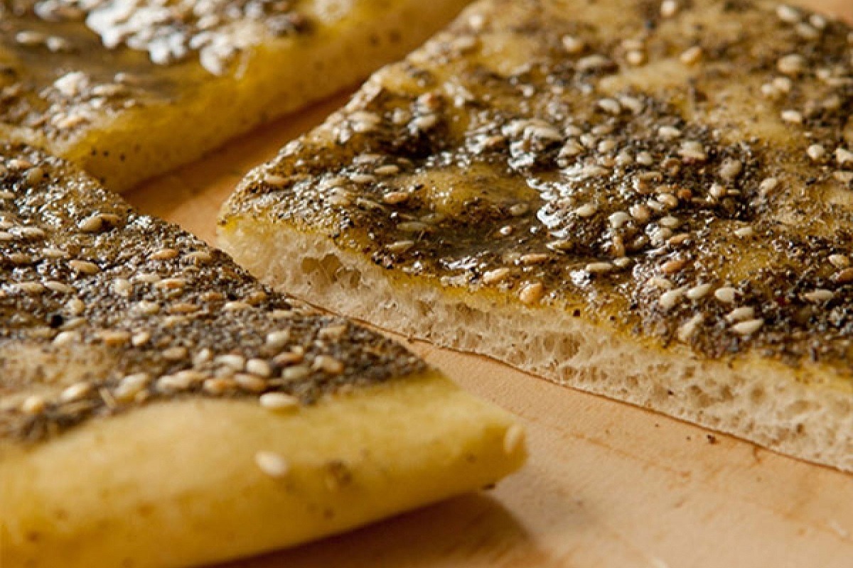 Zatar bread cut on wooden board