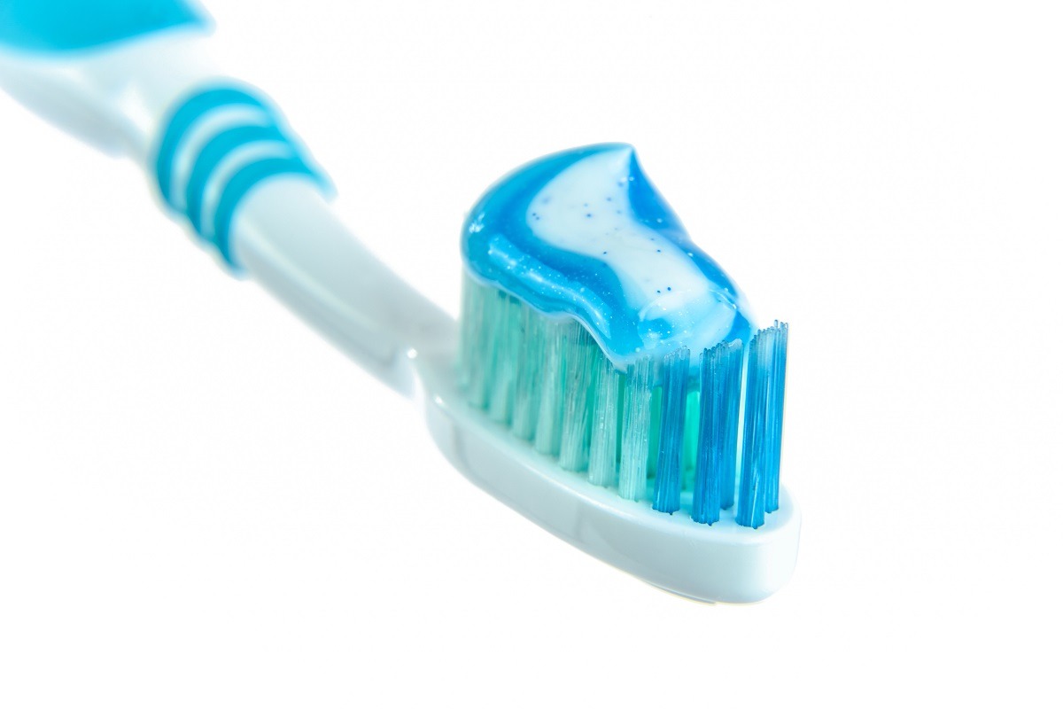white toothbrush with blue toothpaste