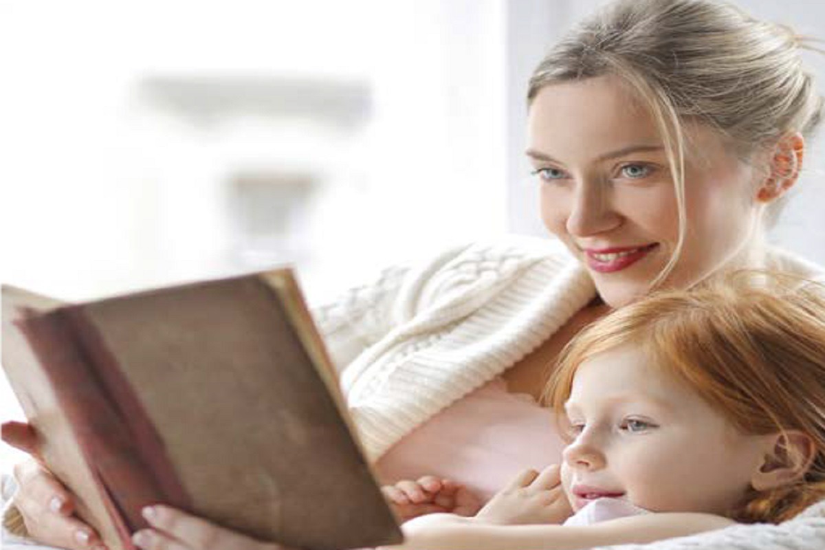 mother reading story to daughter in bed