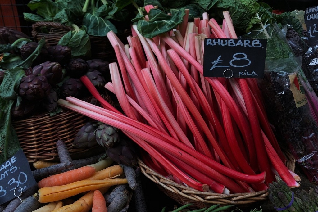 Rhubarb in a basket with a price tag on it