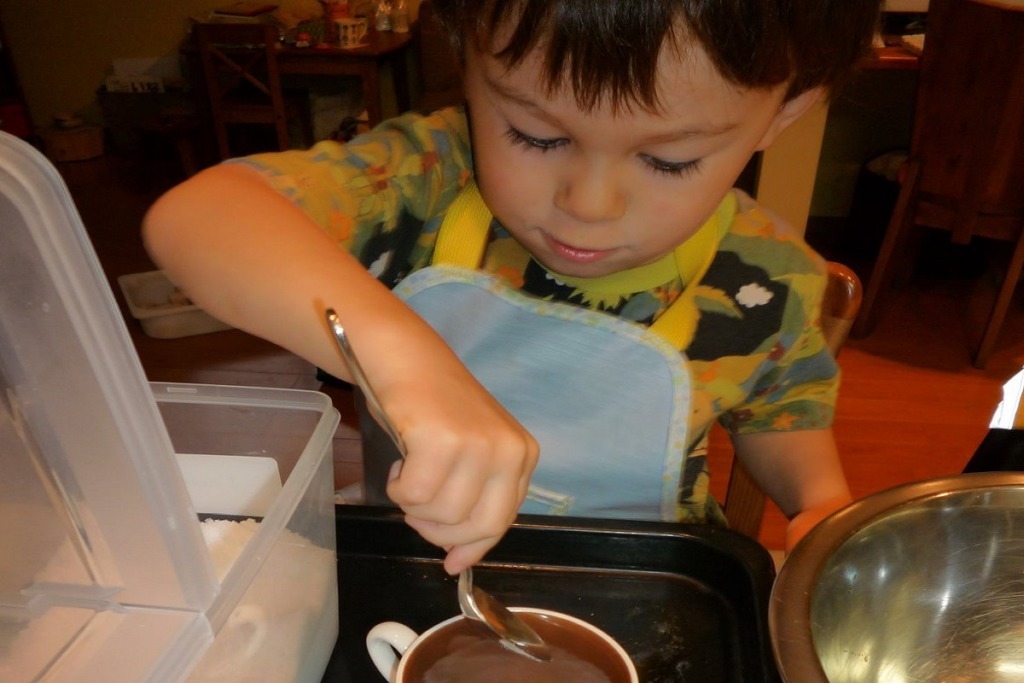 boy in apron with spoon