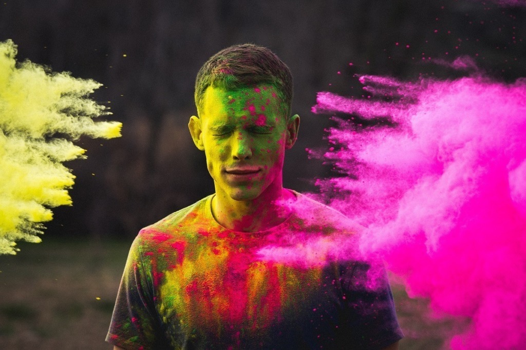 man dusted with coloured powder