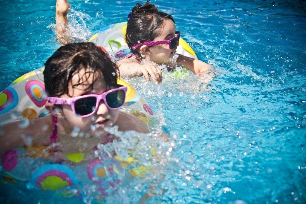 girl toddlers swimming with sunglasses