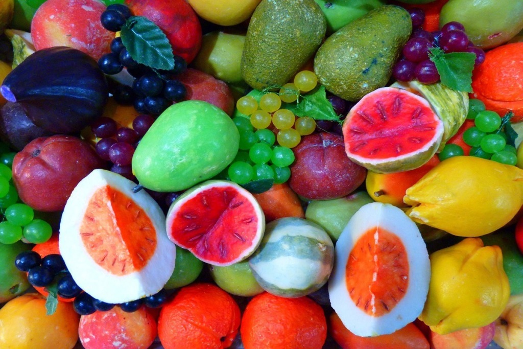 collection of artificial fruits whole and cut