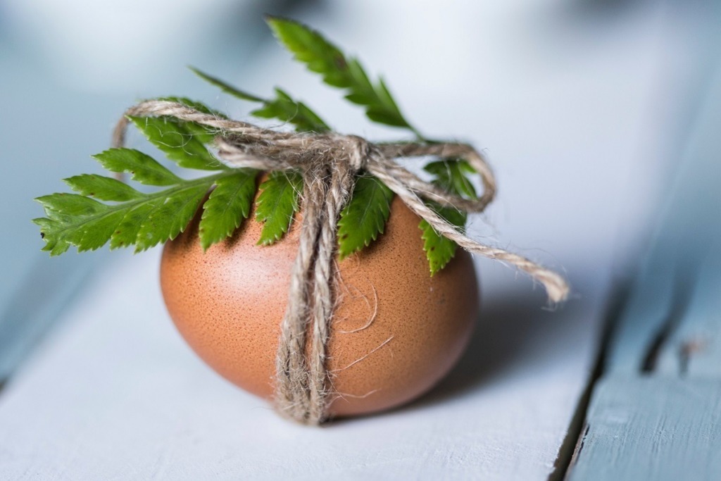 egg with green leaf tied with string