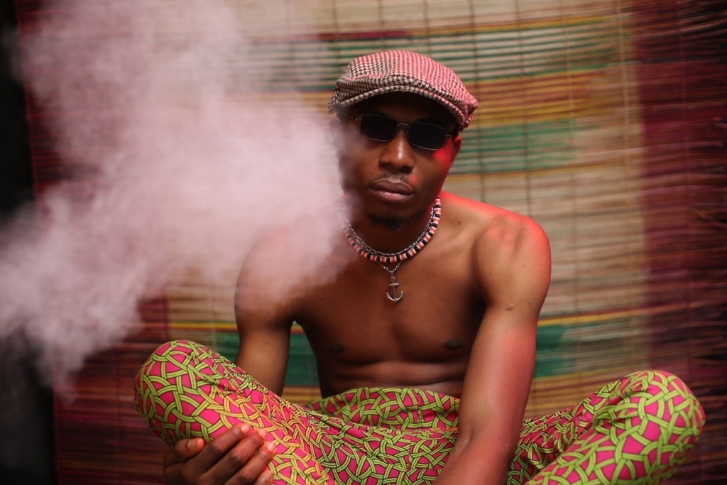 African man sitting in smoke