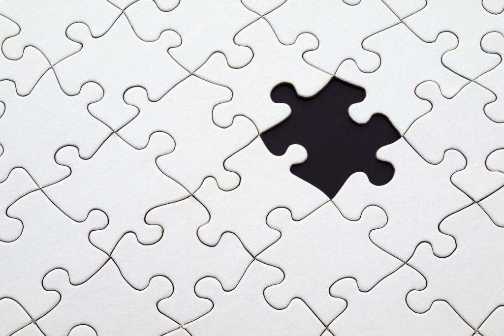 white jigsaw puzzle with one piece missing