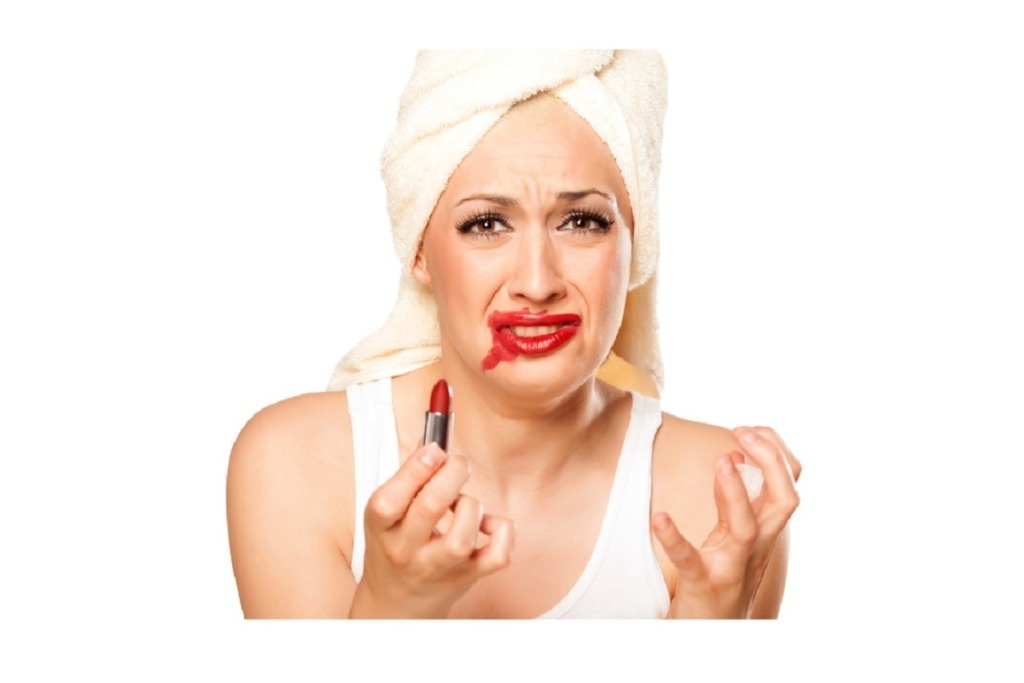 woman in white top with smeared lipstick on face