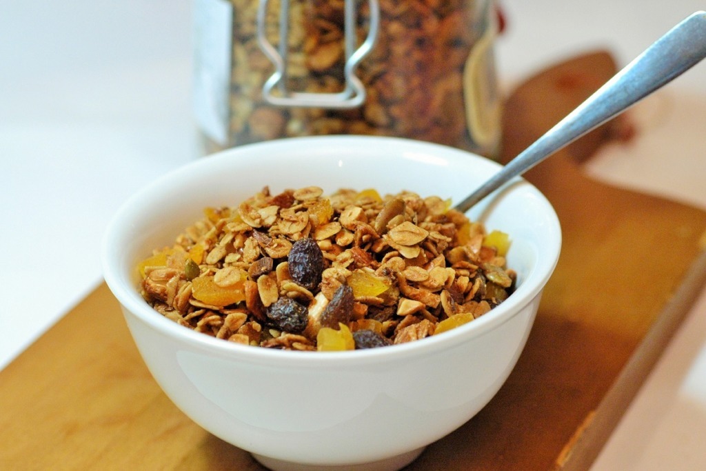 white bowl of granola on wooden board